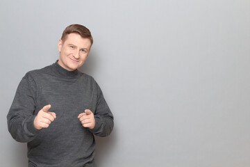 Portrait of happy confident mature man pointing with fingers at you