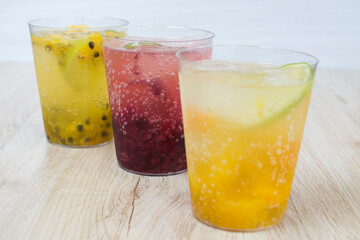 italian flavored sodas with ice and tropical flavors on white wooden background