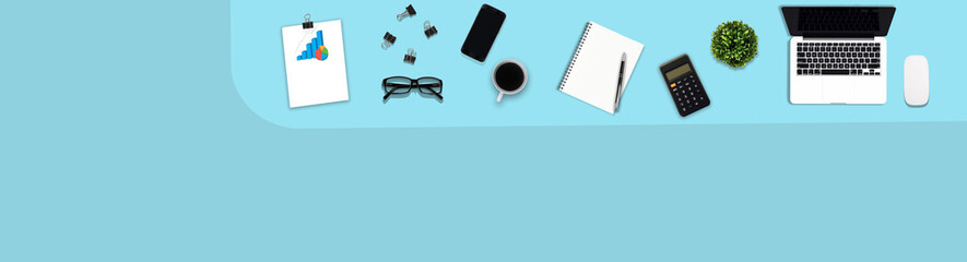 Digital tablet with blank screen and notebook, pen, black metallic paper clips, calculator, coffee cup, eyeglasses and laptop on pastel color background, flat lay, Top view. 