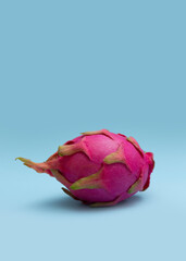 Ripe whole dragon fruit with white flesh. The pink pitaya fruit is low in calories, rich in essential vitamins and minerals, and contains dietary fiber.