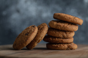 Delicious cookies with chocolate on a gray background