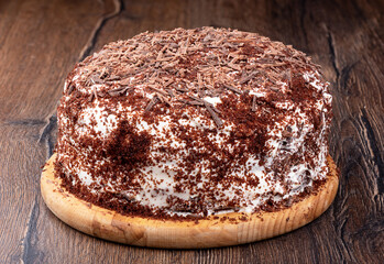 Chocolate cream cake sprinkled with chocolate chips.