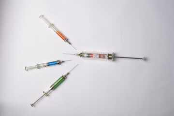 medical syringes with different liquids on a white background