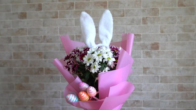 easter flowers bouquet with rabbit ears and eggs. happy easter