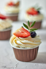 Cupcake decorated with strawberries and blueberries