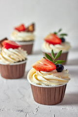 Cupcake decorated with strawberries and blueberries
