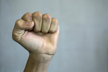 The teen's fist raised the top against a white background.