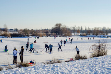 people skating on a frozen pond in winter