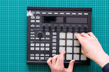 dj audio producer fingers play the drum music on pads of drum machine