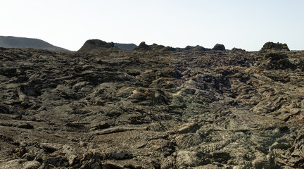 Black lava solidified at Timanfaya National Park. Volcanic natural landscape in Lanzarote island. Travel destination, tourism attraction concepts