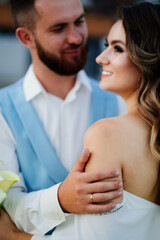 bride with long curls in a white elegant dress with