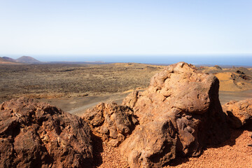 Red rocks at Timanfaya National Park on sunny day. Volcanic natural landscape in Lanzarote island....