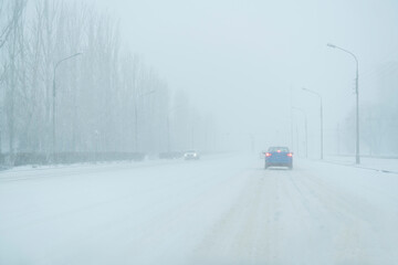 dangerous stormy weather in the city, collapse, snowfall on highway, winter season