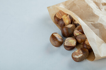 Bunch of roasted chestnuts in brown paper