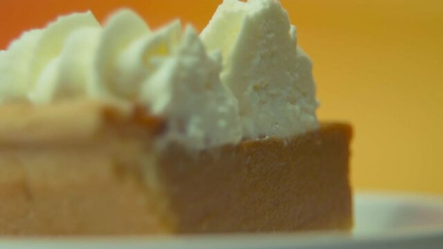 [Camera Used: Canon C300] Macro static shot, rack focus, pumpkin pie slice loaded with fluffy whipped cream! Check out this seller's other videos for more variation of this clip from the same series!