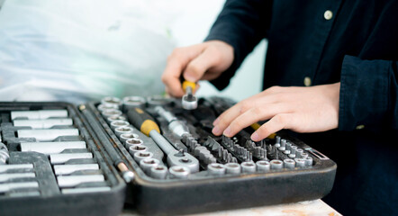 worker hand taking the tool from the set case to do make the project