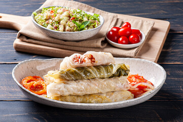 
Arabic food. Appetizing cabbage rolls on wood background. Dolma, sarma, or golubtsy - traditional dish of many countries