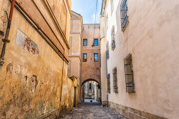 Lviv, Ukraine colorful pastel building historical architecture in Ukrainian city with passage archway narrow alley street