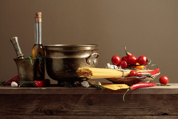 Pasta with ingredients on a old wooden table.
