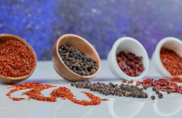 Many bowls of spices on a white background