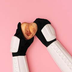 Storm trooper hands are offering heart covered in raw meat on pink background.