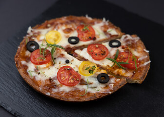 Low-carb keto diet Pizza with mozzarella and tomato crust with cheese filling. Low carb keto diet cake made from almond flour and mozzarella instead of classic pizza.
