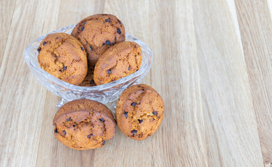 Cookies with brown chocolate in a crystal cup with wood background
