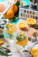 Hard seltzer cocktail with orange and zero waste bartenders accessories