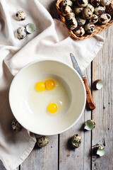 Broken quail eggs in a bowl.