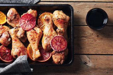 Baked chicken legs with oranges.