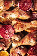 Baked chicken legs with oranges.