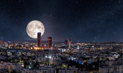 Full moon above modern buildings in the new downtown of Amman city
