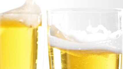 glass of beer with foam hitting other glass of beer slow motion High Key White Background Cheers