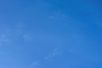 Background image of a clear blue sky with small clouds