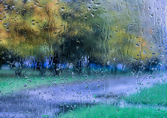 View of street through glass with rain drops.