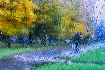 Fototapeta na wymiar View of street through glass with rain drops.