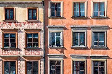 Fototapeta premium Warsaw, Poland closeup of wall in rynek old town market square with historic architecture windows closeup pattern of orange brown colors