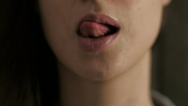 Portrait of woman who seductive lick one's lips 