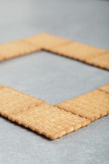 Delicious fresh crackers on a gray background