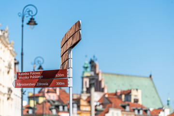 Warsaw, Poland old town historic street buildings in city during sunny summer day in castle square and direction information sign for Katedra Polowa