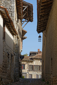PEROUGES, FRANCE, February 23, 2021 : A street of the old medieval town. The town was restored and houses were saved in the beginning of 20th century and is now a popular tourist attraction.