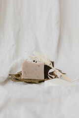 Handmade natural soap on a vintage tray with dried flowers on a white background.