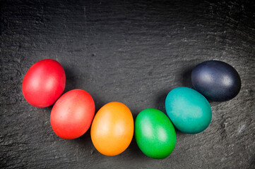 Colorful easter eggs - flat lay on black background