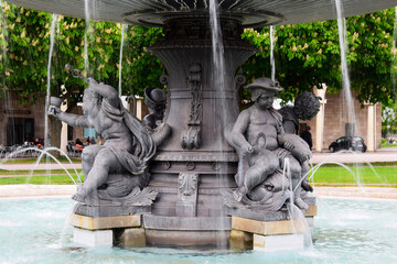 Working fountain with figures of children and fish in the city Park