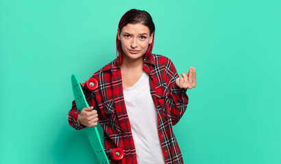 young attractive red hair woman making capice or money gesture, telling you to pay your debts! and...