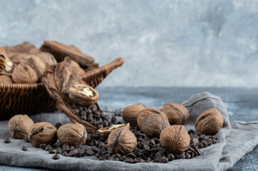 Healthy walnuts with aroma coffee beans on a gray tablecloth