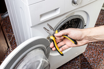 laundry washing machine repair concept. handyman fix washing appliance