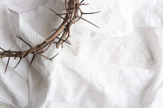 Crown of thorns on white linen with copy space