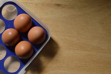 Top view of chicken eggs over wooden background.