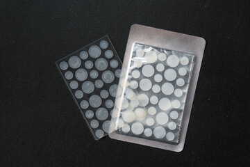 Round patches for acne and wrinkles on a black background. Acne and wrinkle patches for facial...
